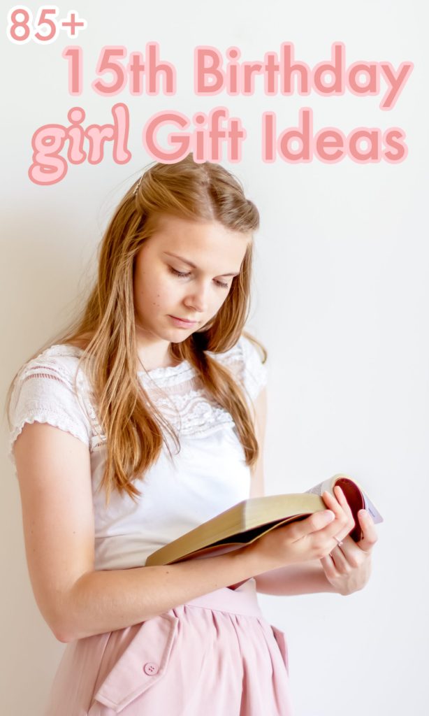young girl in white shirt and pink skirt reading a book.