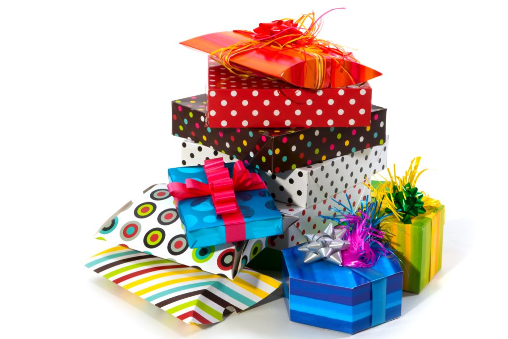 stack of colorful presents with ribbons and bows.