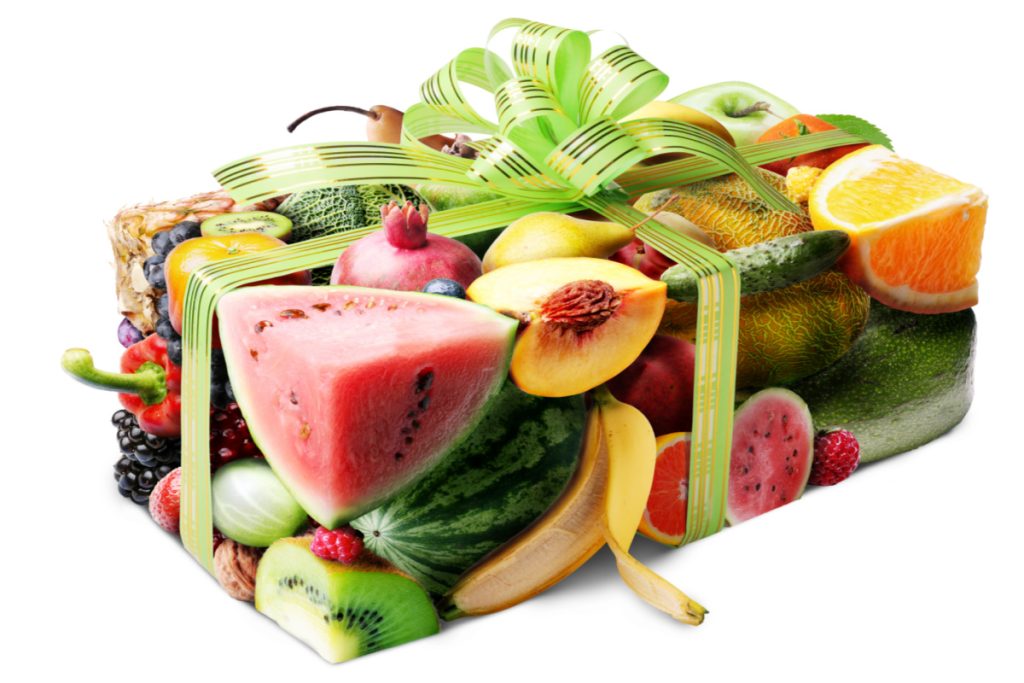box wrapped in fruit print paper with green bow.