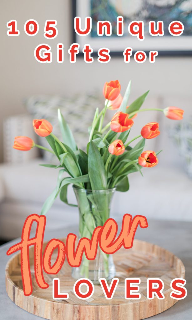 glass vase with orange tulips on table in living room.