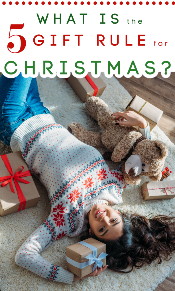 smiling woman laying on rug with 5 wrapped gifts scattered around her.